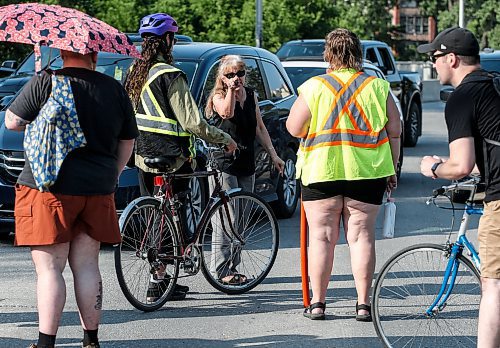 JOHN WOODS / FREE PRESS
A motorist talks to cyclists who blocked cars at the intersection of Academy and Wellington Tuesday, July 30, 2024. Cyclists want safe infrastructure after a child was hit by a driver at the intersection yesterday.

Reporter: ?