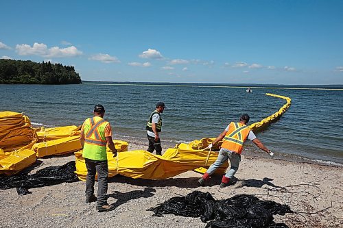 31072024
Workers with ASI Group work to move silt curtains into Clear Lake at the Clear Lake boat cove in Riding Mountain National Park on Wednesday. The silt curtains are being set up in Clear Lake from boat cove to the pier as part of extensive work by Parks Canada in the wake of limited zebra mussel activity being found in the lake. 
(Tim Smith/The Brandon Sun)