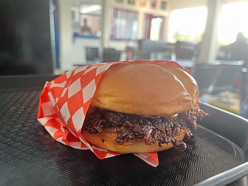 A &quot;smash-burger&quot; style hamburger at Minnedosa's Dari Isle Drive In, done &quot;Isle Style&quot; with their signature smash sauce and a pickle. (Matt Goerzen/The Brandon Sun)