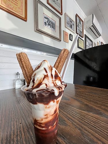 The churro parfait, a local favourite at Minnedosa's Dary Isle Drive-In, is made with two fried and warm churro donuts dipped in cinnamon and sugar, with vanilla soft serve and hot fudge. (Matt Goerzen/The Brandon Sun)