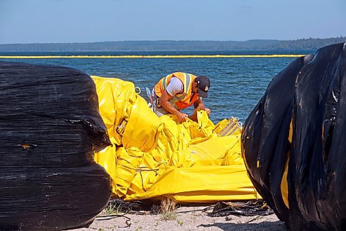 31072024
Workers with ASI Group unpackage and link silt curtains at the Clear Lake boat cove in Riding Mountain National Park on Wednesday. The silt curtains are being set up in Clear Lake from boat cove to the pier as part of extensive work by Parks Canada in the wake of limited zebra mussel activity being found in the lake. 
(Tim Smith/The Brandon Sun)