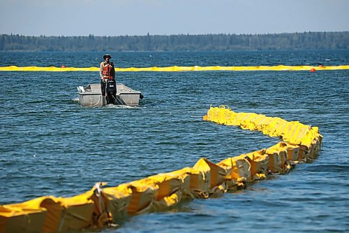 31072024
Workers with ASI Group work to move silt curtains into Clear Lake at the Clear Lake boat cove in Riding Mountain National Park on Wednesday. The silt curtains are being set up in Clear Lake from boat cove to the pier as part of extensive work by Parks Canada in the wake of limited zebra mussel activity being found in the lake. 
(Tim Smith/The Brandon Sun)