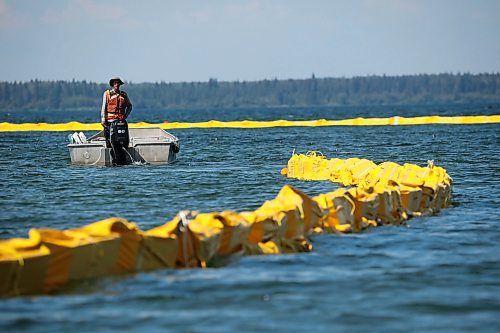 31072024
Workers with ASI Group work to move silt curtains into Clear Lake at the Clear Lake boat cove in Riding Mountain National Park on Wednesday. The silt curtains are being set up in Clear Lake from boat cove to the pier as part of extensive work by Parks Canada in the wake of limited zebra mussel activity being found in the lake. 
(Tim Smith/The Brandon Sun)