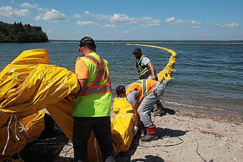 31072024
Workers with ASI Group work to move silt curtains into Clear Lake at the Clear Lake boat cove in Riding Mountain National Park on Wednesday. The silt curtains are being set up in Clear Lake from boat cove to the pier as part of extensive work by Parks Canada in the wake of limited zebra mussel activity being found in the lake. 
(Tim Smith/The Brandon Sun)