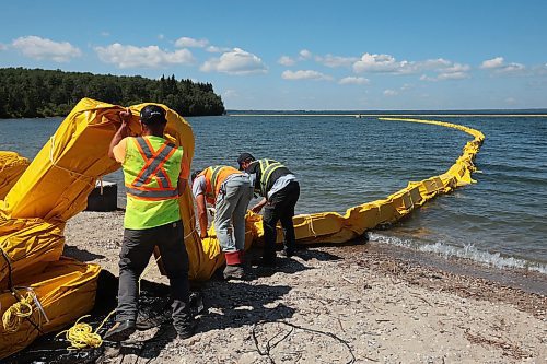 31072024
Workers with ASI Group work to move silt curtains into Clear Lake at the Clear Lake boat cove in Riding Mountain National Park on Wednesday. The silt curtains are being set up in Clear Lake from boat cove to the pier as part of extensive work by Parks Canada in the wake of limited zebra mussel activity being found in the lake. 
(Tim Smith/The Brandon Sun)