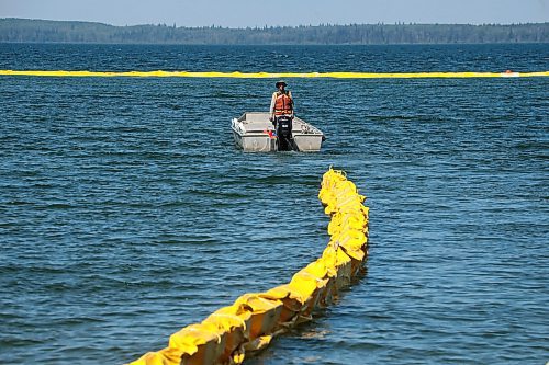 31072024
Workers with ASI Group work to move silt curtains into Clear Lake at the Clear Lake boat cove in Riding Mountain National Park on Wednesday. The silt curtains are being set up in Clear Lake from boat cove to the pier as part of extensive work by Parks Canada in the wake of limited zebra mussel activity being found in the lake. 
(Tim Smith/The Brandon Sun)