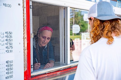 NIC ADAM / FREE PRESS
Manager Tessa Galbichka (left) takes and order from Tyler Horsfall at Brian's Drive-Inn Wednesday. Horsfall says he frequents Brian&#x2019;s because it&#x2019;s cheap, good, and local.
240731 - Wednesday, July 31, 2024.

Reporter: Dave
