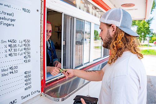 NIC ADAM / FREE PRESS
Manager Tessa Galbichka (left) takes and order from Tyler Horsfall at Brian's Drive-Inn Wednesday. Horsfall says he frequents Brian&#x2019;s because it&#x2019;s cheap, good, and local.
240731 - Wednesday, July 31, 2024.

Reporter: Dave
