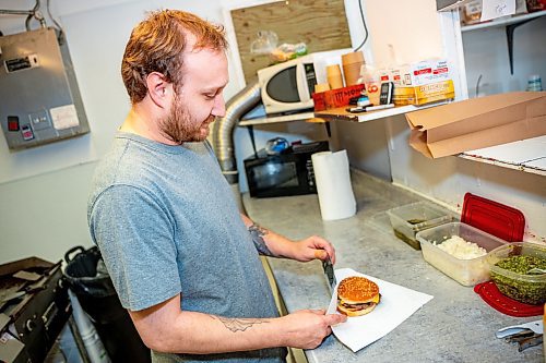 NIC ADAM / FREE PRESS
Brenden Galbichka, cook at Brian&#x2019;s and son of Tessa, pictured making burgers in the kitchen of Brian&#x2019;s Drive-Inn Wednesday.
240731 - Wednesday, July 31, 2024.

Reporter: Dave
