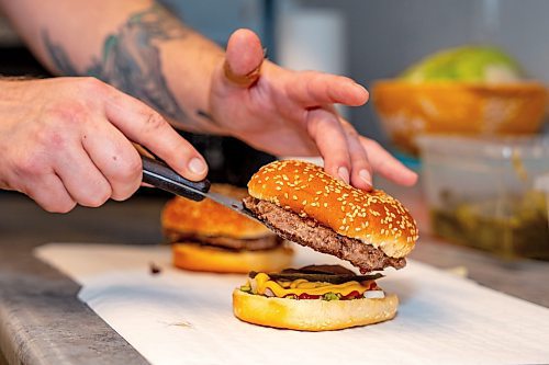 NIC ADAM / FREE PRESS
Brenden Galbichka, cook at Brian&#x2019;s and son of Tessa, pictured making burgers in the kitchen of Brian&#x2019;s Drive-Inn Wednesday.
240731 - Wednesday, July 31, 2024.

Reporter: Dave
