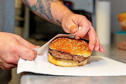 NIC ADAM / FREE PRESS
Brenden Galbichka, cook at Brian&#x2019;s and son of Tessa, pictured making burgers in the kitchen of Brian&#x2019;s Drive-Inn Wednesday.
240731 - Wednesday, July 31, 2024.

Reporter: Dave
