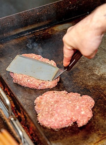 NIC ADAM / FREE PRESS
Brenden Galbichka, cook at Brian&#x2019;s and son of Tessa, pictured making burgers in the kitchen of Brian&#x2019;s Drive-Inn Wednesday.
240731 - Wednesday, July 31, 2024.

Reporter: Dave
