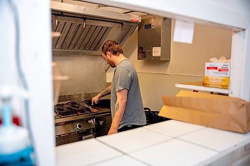 NIC ADAM / FREE PRESS
Brenden Galbichka, cook at Brian&#x2019;s and son of Tessa, pictured making burgers in the kitchen of Brian&#x2019;s Drive-Inn Wednesday.
240731 - Wednesday, July 31, 2024.

Reporter: Dave
