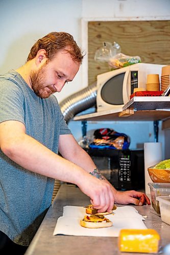 NIC ADAM / FREE PRESS
Brenden Galbichka, cook at Brian&#x2019;s and son of Tessa, pictured making burgers in the kitchen of Brian&#x2019;s Drive-Inn Wednesday.
240731 - Wednesday, July 31, 2024.

Reporter: Dave
