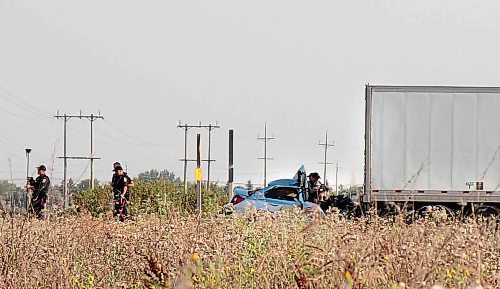 TYLER SEARLE / FREE PRESS

City police were on the scene of a serious collision on Centreport Canada Way Wednesday evening, where a silver sedan was seen trapped beneath the rear end of a tractor-trailer.