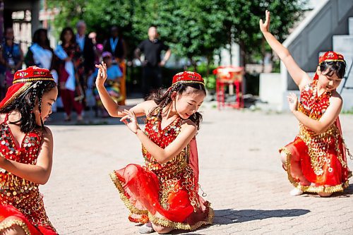 MIKAELA MACKENZIE / FREE PRESS
	

Nine-year-olds Sophia Liang (left), Zoey Jian, and Ivy He dance at the Folklorama kickoff at the Winnipeg Chinese Cultural and Community Centre on Thursday, Aug. 1, 2024. 

