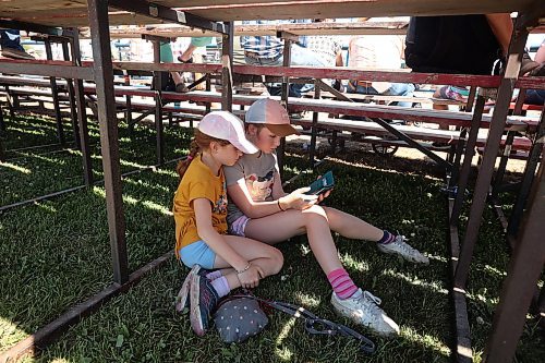 01082024
Sisters Rylee and Madison Nykoliation stay cool under a set of bleachers during the first go-round of the 2024 Canadian High School Rodeo Finals at the Keystone Centre on a scorching hot Thursday. Approximately 250 contestants from across the country are competing in the finals, which wrap up Saturday.
(Tim Smith/The Brandon Sun)