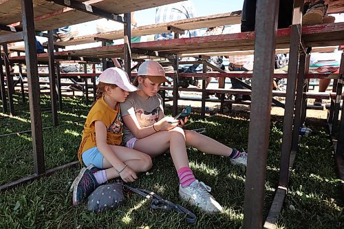 01082024
Sisters Rylee and Madison Nykoliation stay cool under a set of bleachers during the first go-round of the 2024 Canadian High School Rodeo Finals at the Keystone Centre on a scorching hot Thursday. Approximately 250 contestants from across the country are competing in the finals, which wrap up Saturday.
(Tim Smith/The Brandon Sun)