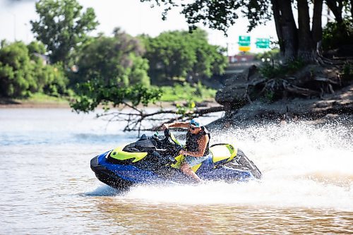 MIKAELA MACKENZIE / FREE PRESS

	
T. J. Gardiner cools down by splashing down the Red River on a Sea-Doo (from St. Vital Park to The Forks and back) on Thursday, Aug. 1, 2024. 

For heat story.