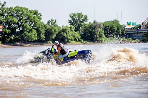 MIKAELA MACKENZIE / FREE PRESS

	
T. J. Gardiner cools down by splashing down the Red River on a Sea-Doo (from St. Vital Park to The Forks and back) on Thursday, Aug. 1, 2024. 

For heat story.