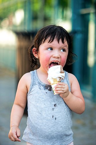 MIKAELA MACKENZIE / FREE PRESS

	
Two-year-old Secora Raven eats an ice cream after cooling down at the splash pad at The Forks on Thursday, Aug. 1, 2024. 

For heat story.