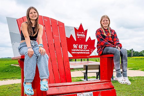 NIC ADAM / FREE PRESS
Ava Swedlo (left) and Maddie Murray from Winnipeg pictured at the longitudinal centre of Canada, just off hwy 1 Tuesday.
240723 - Tuesday, July 23, 2024.

Reporter: Jura