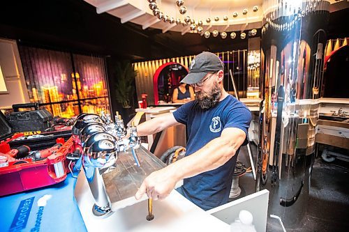 MIKAELA MACKENZIE / FREE PRESS

Jamie Funke, tech with Prairie Beverage Services, installs the beer taps at the in-progress Barcade space in the East Exchange on Wednesday, July 24, 2024. 

For Eva story.