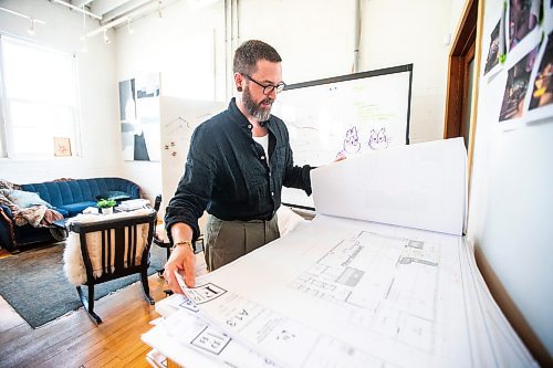 MIKAELA MACKENZIE / FREE PRESS

	
Co-owner Adam Bumbolo pulls out plans for the Barcade space at Fireside Design offices on Wednesday, July 31, 2024. 

For Eva story.