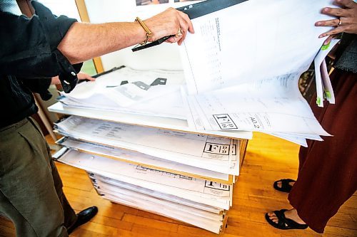 MIKAELA MACKENZIE / FREE PRESS

	
Co-owners Adam Bumbolo (left) and Jaclyn Wiebe flip through design plans at Fireside Design offices on Wednesday, July 31, 2024. 

For Eva story.