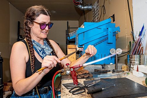 NIC ADAM / FREE PRESS
Glass worker Brook Drabot pictured blowing glass in the garage studio of her Warren home Friday. Brook loves making very small things, blowing glass to create tiny vases, miniature ornaments and small bowls. 
240801 - Thursday, August 01, 2024.

Reporter: