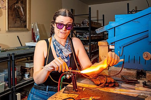 NIC ADAM / FREE PRESS
Glass worker Brook Drabot pictured blowing glass in the garage studio of her Warren home Friday. Brook loves making very small things, blowing glass to create tiny vases, miniature ornaments and small bowls. 
240801 - Thursday, August 01, 2024.

Reporter: