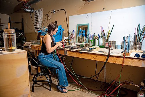 NIC ADAM / FREE PRESS
Glass worker Brook Drabot pictured blowing glass in the garage studio of her Warren home Friday. Brook loves making very small things, blowing glass to create tiny vases, miniature ornaments and small bowls. 
240801 - Thursday, August 01, 2024.

Reporter: