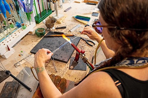 NIC ADAM / FREE PRESS
Glass worker Brook Drabot pictured blowing glass in the garage studio of her Warren home Friday. Brook loves making very small things, blowing glass to create tiny vases, miniature ornaments and small bowls. 
240801 - Thursday, August 01, 2024.

Reporter: