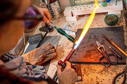 NIC ADAM / FREE PRESS
Glass worker Brook Drabot pictured blowing glass in the garage studio of her Warren home Friday. Brook loves making very small things, blowing glass to create tiny vases, miniature ornaments and small bowls. 
240801 - Thursday, August 01, 2024.

Reporter: