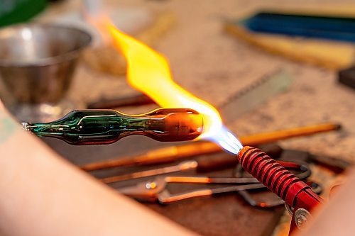 NIC ADAM / FREE PRESS
Glass worker Brook Drabot pictured blowing glass in the garage studio of her Warren home Friday. Brook loves making very small things, blowing glass to create tiny vases, miniature ornaments and small bowls. 
240801 - Thursday, August 01, 2024.

Reporter: