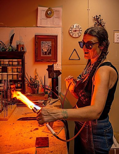 NIC ADAM / FREE PRESS
Glass worker Brook Drabot pictured blowing glass in the garage studio of her Warren home Friday. Brook loves making very small things, blowing glass to create tiny vases, miniature ornaments and small bowls. 
240801 - Thursday, August 01, 2024.

Reporter: