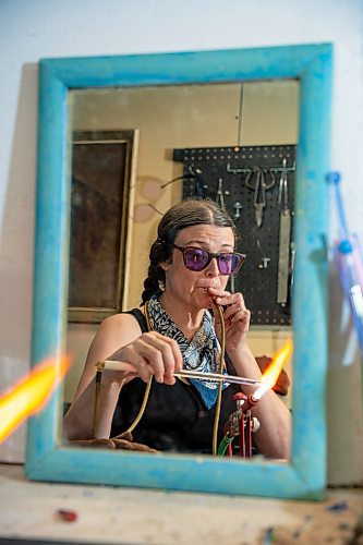 NIC ADAM / FREE PRESS
Glass worker Brook Drabot pictured blowing glass in the garage studio of her Warren home Friday. Brook loves making very small things, blowing glass to create tiny vases, miniature ornaments and small bowls. 
240801 - Thursday, August 01, 2024.

Reporter: