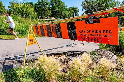 NIC ADAM / FREE PRESS
Residents say the huge hole we reported on last year, pictured Friday, remains alongside the Sturgeon Creek pathway. Coun. Shawn Dobson said he agrees as it poses a safety hazard, though the city has a plan to fix it. 
240802 - Friday, August 02, 2024.

Reporter: Joyanne
