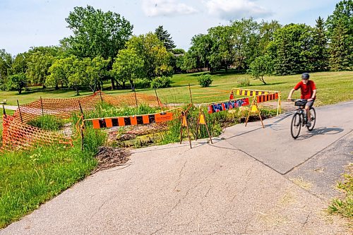 NIC ADAM / FREE PRESS
Residents say the huge hole we reported on last year, pictured Friday, remains alongside the Sturgeon Creek pathway. Coun. Shawn Dobson said he agrees as it poses a safety hazard, though the city has a plan to fix it. 
240802 - Friday, August 02, 2024.

Reporter: Joyanne
