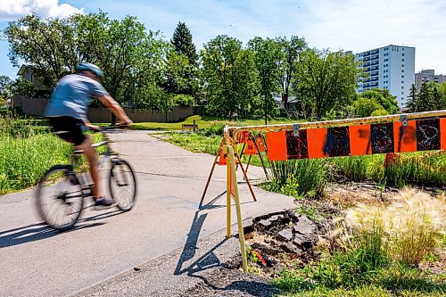 NIC ADAM / FREE PRESS
Residents say the huge hole we reported on last year, pictured Friday, remains alongside the Sturgeon Creek pathway. Coun. Shawn Dobson said he agrees as it poses a safety hazard, though the city has a plan to fix it. 
240802 - Friday, August 02, 2024.

Reporter: Joyanne
