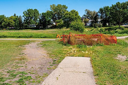 NIC ADAM / FREE PRESS
Residents say the huge hole we reported on last year, pictured Friday, remains alongside the Sturgeon Creek pathway. Coun. Shawn Dobson said he agrees as it poses a safety hazard, though the city has a plan to fix it. 
240802 - Friday, August 02, 2024.

Reporter: Joyanne
