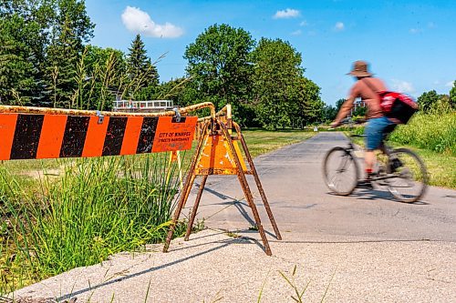 NIC ADAM / FREE PRESS
Residents say the huge hole we reported on last year, pictured Friday, remains alongside the Sturgeon Creek pathway. Coun. Shawn Dobson said he agrees as it poses a safety hazard, though the city has a plan to fix it. 
240802 - Friday, August 02, 2024.

Reporter: Joyanne
