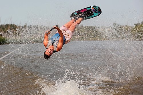 02082024
Professional waterskier Bradley Gibbons of Calgary flips through the air while trick skiing with the Brandon Waterski Club on the Assiniboine River on Friday afternoon. Gibbons has been in Manitoba leading coaching clinics for the past few weeks including a two-day clinic with the Brandon Waterski Club.
(Tim Smith/The Brandon Sun)