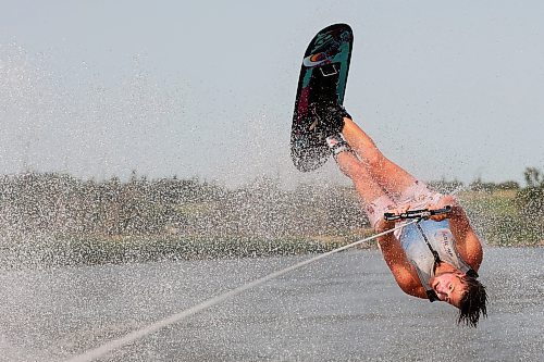 02082024
Professional waterskier Bradley Gibbons of Calgary flips through the air while trick skiing with the Brandon Waterski Club on the Assiniboine River on Friday afternoon. Gibbons has been in Manitoba leading coaching clinics for the past few weeks including a two-day clinic with the Brandon Waterski Club.
(Tim Smith/The Brandon Sun)