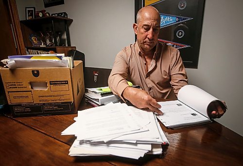 JOHN WOODS / FREE PRESS
Dave Brown, a former coach who took Manitoba Hockey, looks through court documents at his home Monday, August 5, 2024. Brown has abandoned his lawsuit due to the expense and challenge of the case and accepted a out-of-court settlement.

Reporter: tyler