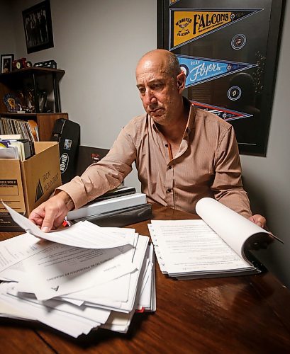 JOHN WOODS / FREE PRESS
Dave Brown, a former coach who took Manitoba Hockey, looks through court documents at his home Monday, August 5, 2024. Brown has abandoned his lawsuit due to the expense and challenge of the case and accepted a out-of-court settlement.

Reporter: tyler