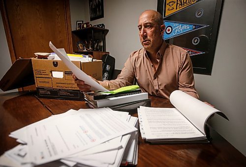 JOHN WOODS / FREE PRESS
Dave Brown, a former coach who took Manitoba Hockey, looks through court documents at his home Monday, August 5, 2024. Brown has abandoned his lawsuit due to the expense and challenge of the case and accepted a out-of-court settlement.

Reporter: tyler