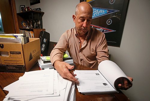 JOHN WOODS / FREE PRESS
Dave Brown, a former coach who took Manitoba Hockey, looks through court documents at his home Monday, August 5, 2024. Brown has abandoned his lawsuit due to the expense and challenge of the case and accepted a out-of-court settlement.

Reporter: tyler