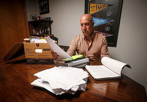 JOHN WOODS / FREE PRESS
Dave Brown, a former coach who took Manitoba Hockey, looks through court documents at his home Monday, August 5, 2024. Brown has abandoned his lawsuit due to the expense and challenge of the case and accepted a out-of-court settlement.

Reporter: tyler