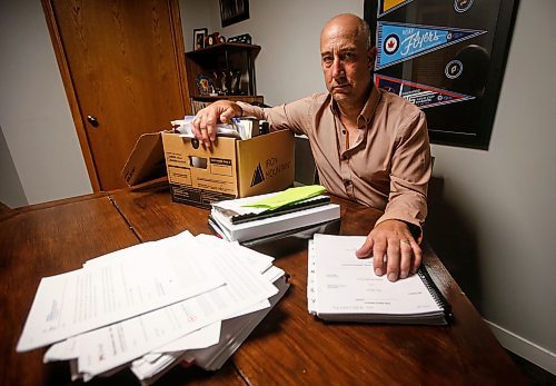 JOHN WOODS / FREE PRESS
Dave Brown, a former coach who took Manitoba Hockey, looks through court documents at his home Monday, August 5, 2024. Brown has abandoned his lawsuit due to the expense and challenge of the case and accepted a out-of-court settlement.

Reporter: tyler